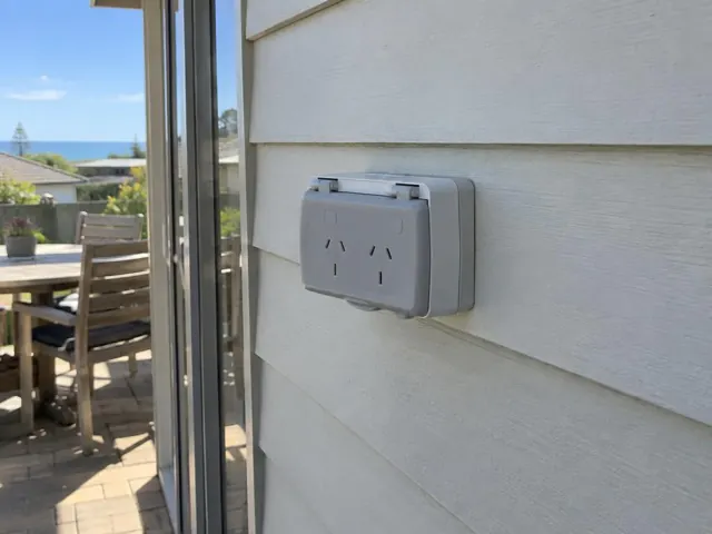 Outdoor double power point on weatherboard wall beside sliding glass door in Norah Head